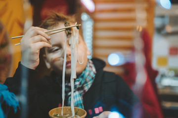 Boy eating in noodle shop