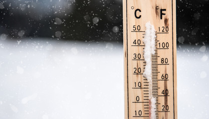 Wooden thermometer in the winter. 