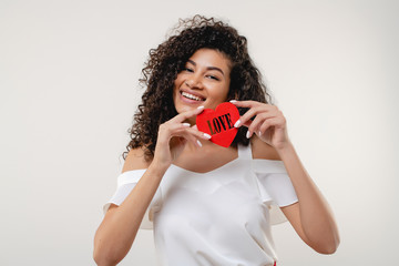 black woman with red heart shaped figure with love letters isolated over white