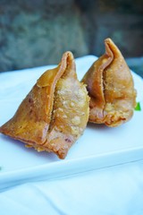 A platter with crispy vegetable samosa turnovers at an Indian restaurant