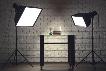 Photo studio with professional equipment shooting books with paper calendar and lavender flowers