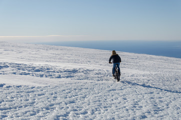 Fototapeta na wymiar Riding a bike on the glacier during winter