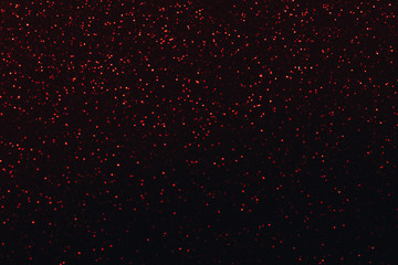 Red glitter bokeh lights on black background, unfocused. Holiday time. overlay layer