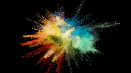 Colored powder explosion, abstract close up dust isolated on black background in slow motion