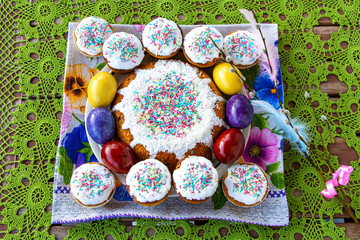 Traditional Easter cake with colored eggs on the crocheted table cloth