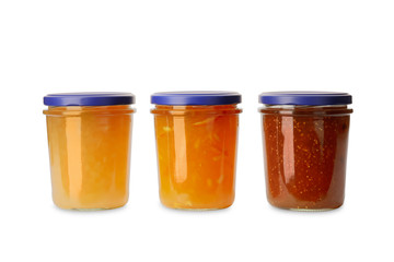 Jars of different delicious jams on white background