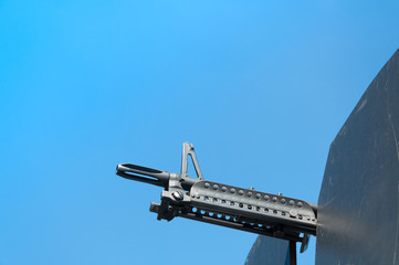 Gun weapons close-up ,machine gun on blue sky,Machine gun on a military vehicle