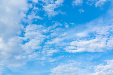 Light cumulus clouds in the blue sky on a sunny day, full frame image, background