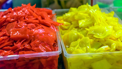 Colorful pickled vegetables. Salting various vegetables in containers for sale. Market. A variety of green vegetables on the table.