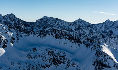 View of the rocky ridge of the High Tatras in winter scenery.