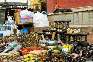 Buddhist and Hindu Souvenirs on a tray in the shop.