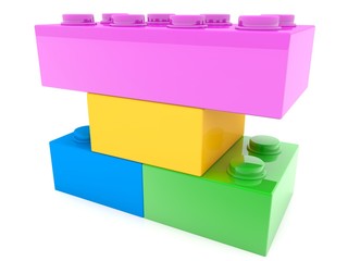 Four toy bricks of different sizes and colors