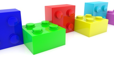Row of colored toy bricks on white