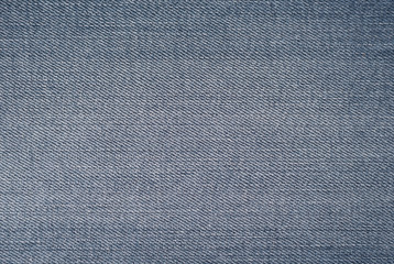 Fototapeta na wymiar Blue denim textured background. Closeup texture and pattern of jeans fabric