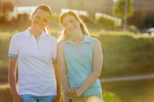 Two female golfers posing together