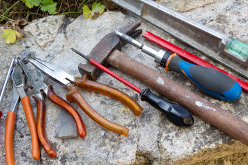 Tools of a construction worker on a wall made in stone