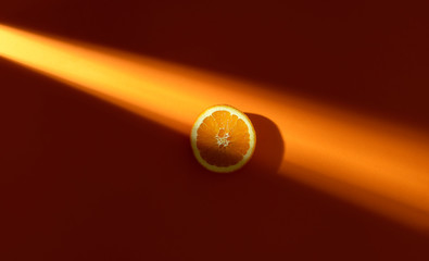 Orange slice in sunlight. Fresh slice of orange. Minimal image