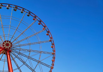 Part of ferris wheel with blue sky background