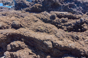 Fototapeta na wymiar Petrified Lava Of Volcanic Rocks Next To The Atlantic Ocean In Hell In Garachico. April 14, 2019. Garachico, Santa Cruz De Tenerife Spain Africa. Travel Tourism Street Photography.
