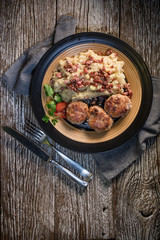 Mince chops served with boiled sauerkraut sprinkled with greaves.