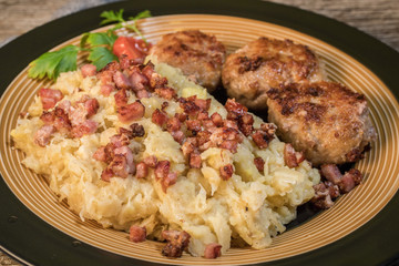 Minced meat cutlets with boiled sauerkraut.
