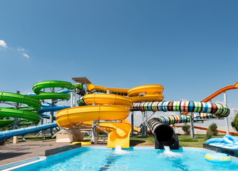 Outdoor water park. Multi-colored slides and pools.