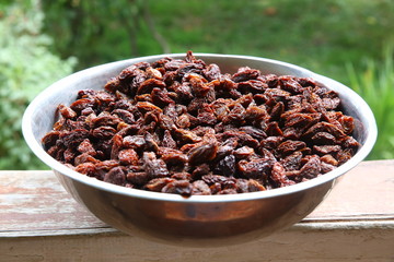 Sweet dry raisins close-up shot for green background . Many Raisins for background grape raisin texture .black raisins in the tray .