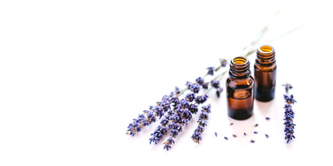 Dried lavender with a bottle of essential oil isolated on white background.