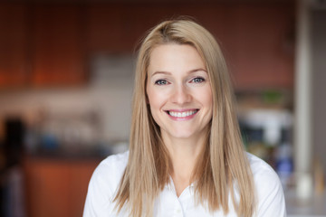 Close up Of A Smiling Caucasien blond woman in the kitchen at home