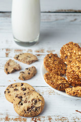 Healthy snack granola whole grain cookies and glass cup of milk on wooden surface. Healthy food and lifestyle concept