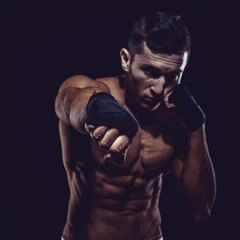 Obraz na płótnie Canvas MMA Fighter Preparing Bandages For Training. Dark background