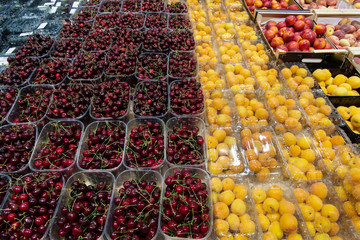 sale of cherries and apricot fruits, in the grocery market