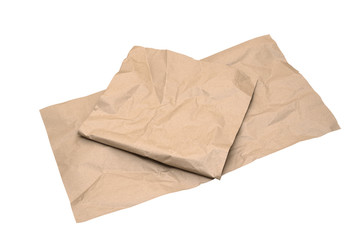 Fototapeta na wymiar Crumpled kraft wrapping paper sheets isolated on white background. Closeup of thick brown paper. Packaging and recycled materials concept. Copy space