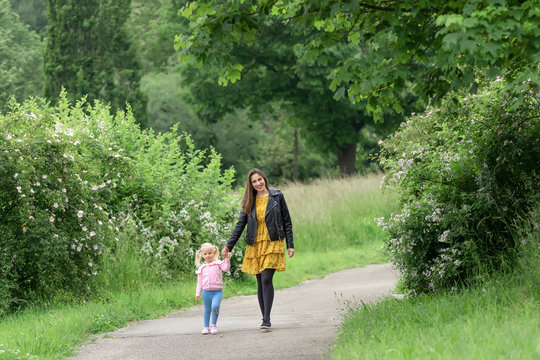 Mom And Daughter Are Walking In The Park