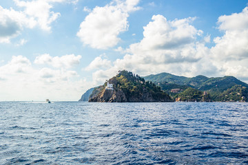 Naklejka premium View from the boat on the white lighthouse of Portofino, Liguria - Italy