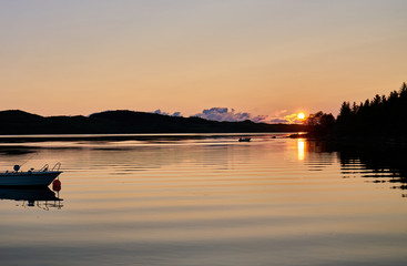 sunset at a fjord on lofoten islands in norway with wave pattern