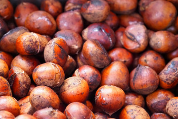 Hot roasted chestnuts, brown food background