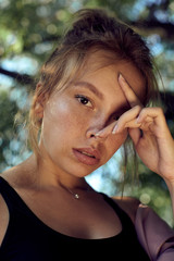 portrait of cute beautiful young girl with freckles close-up