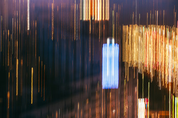 many glowing windows of the night city buildings. Motion blur long exposure light trails abstract composition