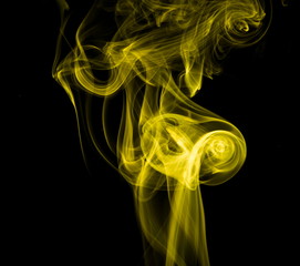 Obraz premium Yellow smoke on black background
