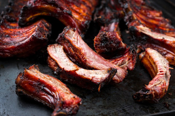 Barbecue pork spare ribs St Louis cut with hot honey chili marinade as closeup on an old rustic metal board