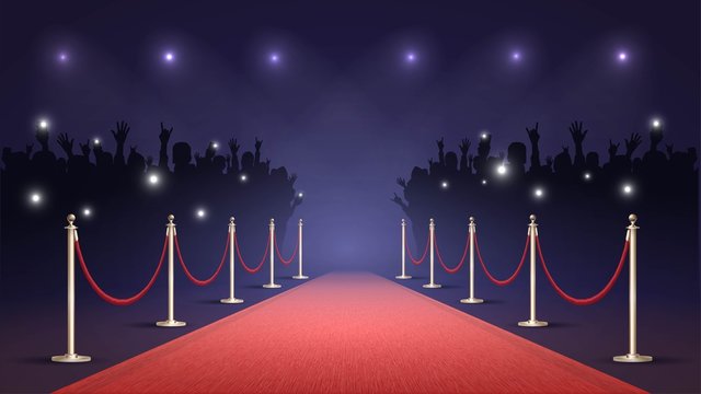Red carpet and crowd of fans, paparazzi photographing a star on the red carpet