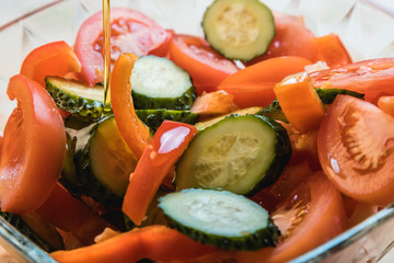 Vegetable salad with olive oil. Sliced vegetables close-up.