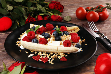 Sweet Homemade Banana Split with yogurt, granola, berries and mint. Banana Split with healthy ingredients