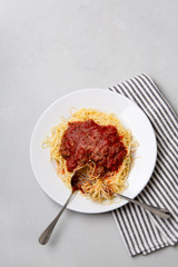 Homemade Spaghetti with Meat Sauce in White Plate on Neutral Gray Background