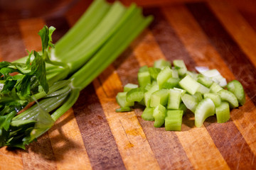 Celery stalks on a wooden cutting board