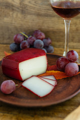 Handmade gouda cheese in herbs and fruits