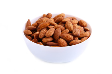 White bowl of almonds isolated on white background