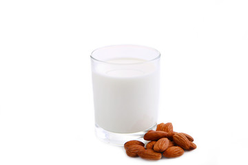 Almond milk in glass with almonds isolated on white background