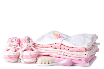 Baby clothes with booties and comb isolated on white background